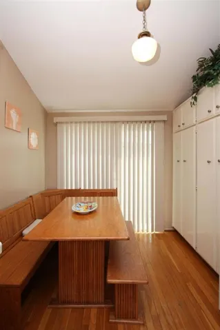 Breakfast sitting area in the kitchen.  Hardwood flooring and sliding doors to the private front patio.