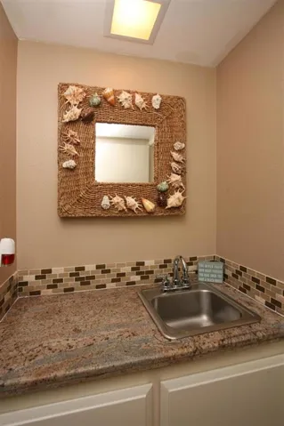Wet bar with granite counter top.