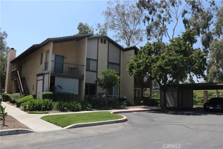 Entry level unit A next to golf fairway with carport.