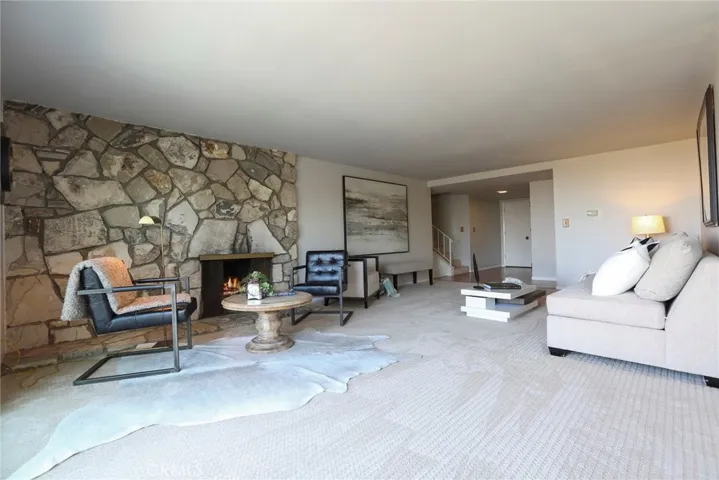 Looking back toward the foyer and half flights of steps to upper or lower levels.
