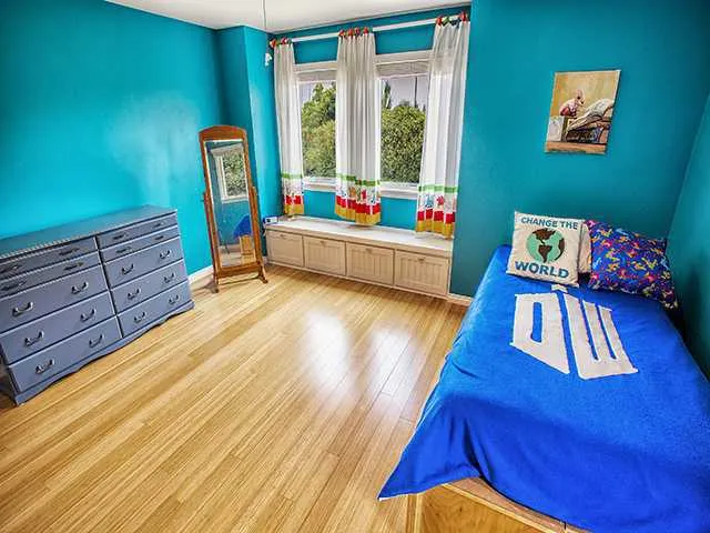 Upper Level Bedroom with Window Seating Overlooking Backyard Pool Area