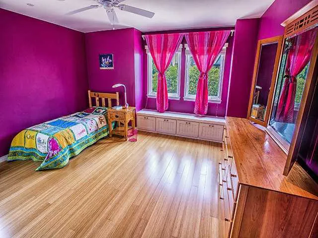 Upper Level Bedroom with Bamboo Floors and Window Seat overlooking Backyard/Pool Area