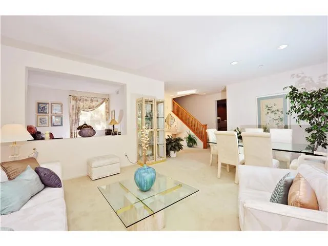 GREAT ROOM POTENTIAL! I  If you would remove a portion of the wall behind the large glass table in background, the entire first floor would be changed into a GREAT ROOM including the Family Room  with fireplace and Kitchen area!