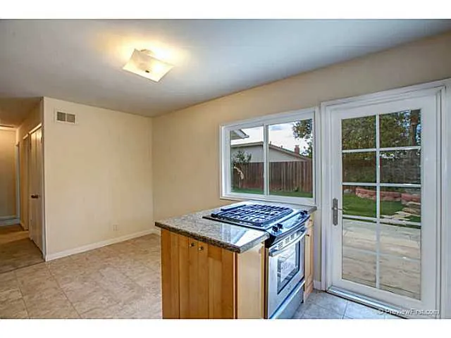 Cooking island looking toward breakfast nook. New door opens to backyard