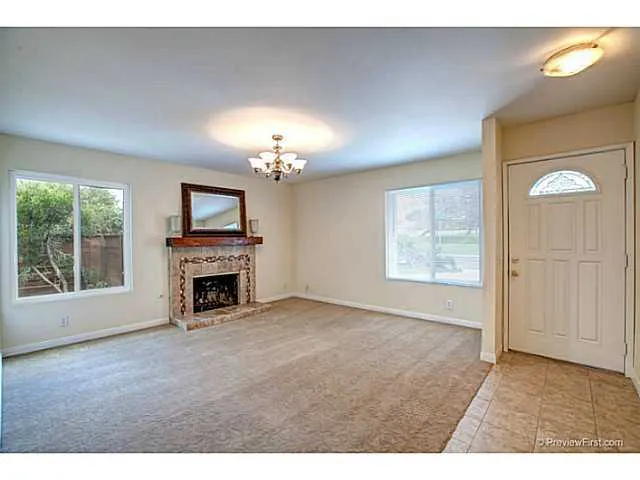 Spacious living room with lots of light and a nicely remodeled fireplace