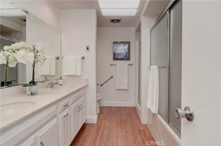 Gleaming bath with dual sink vanity, plus tub and separate shower.