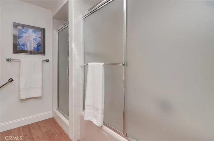 Both the tub and shower have sparking shower enclosures.
