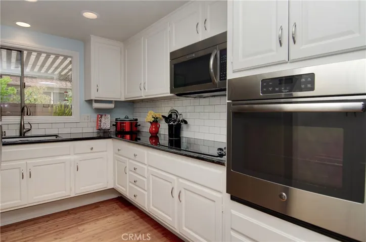 Any chef will love this upgraded kitchen with loads of cabinet space, granite counters, recessed lighting and stainless appliances.