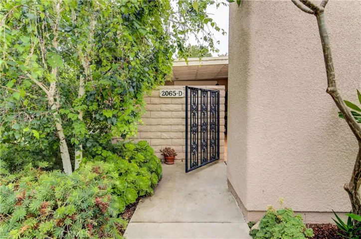 Private walkway and beautiful landscape set the stage for this great home.