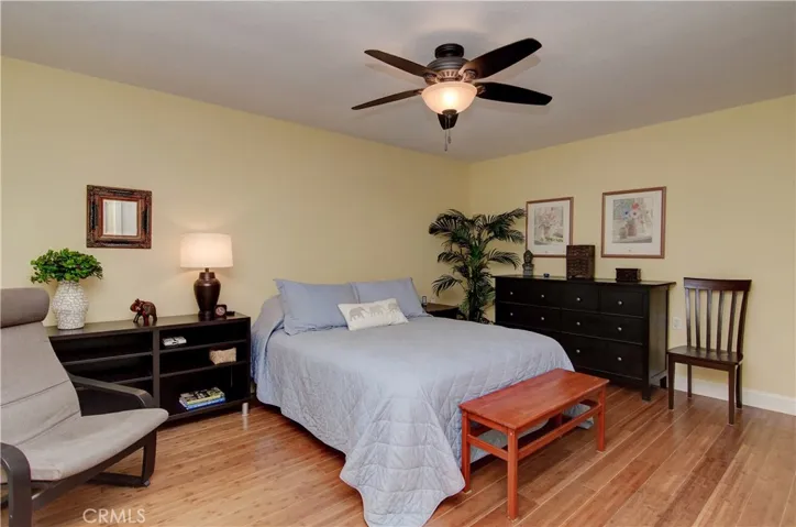 Spacious master bedroom has plenty of room for multiple furniture arrangements, plus tasteful neutral decor.