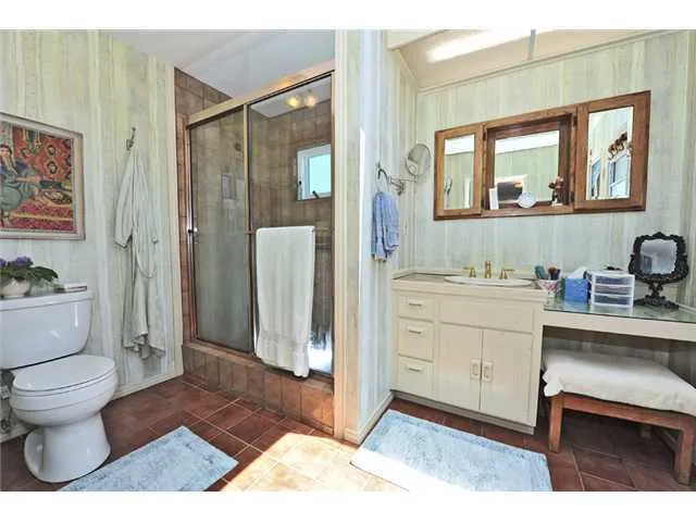 Clear glass door and floor to ceiling tile in master shower.!