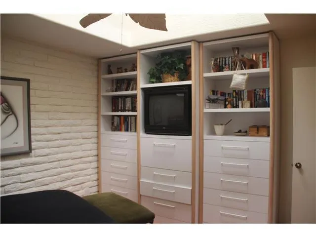 Built-in wall unit in guest/second bedroom.