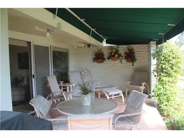 Awning covered garden patio off living room to enjoy your morning coffee or tea.