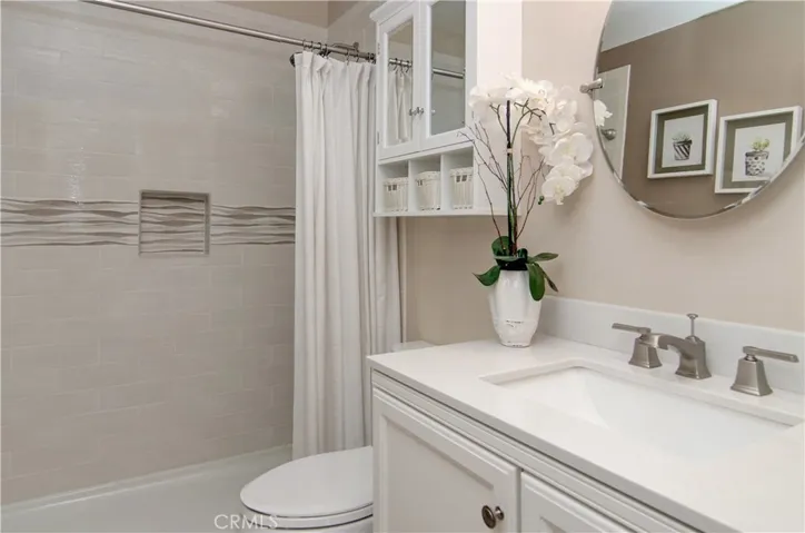 Completely remodeled hall bath has large shower and gorgeous designer details.
