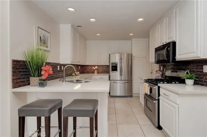 The chef is part of the action here in this bright, remodeled kitchen...bar area is perfect for hanging out with the cook or doing homework.