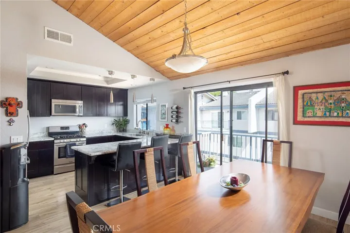 Remodeled kitchen with adjacent dining room and access to balcony