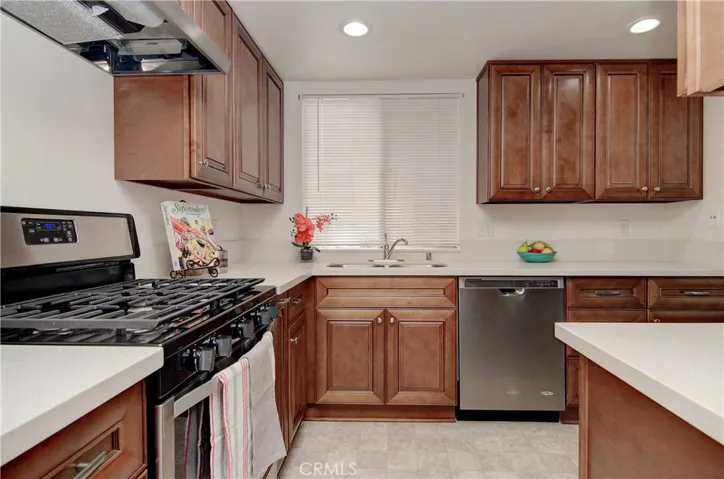 Loads of rich wood cabinetry and counter space...plus a window at the sink...
