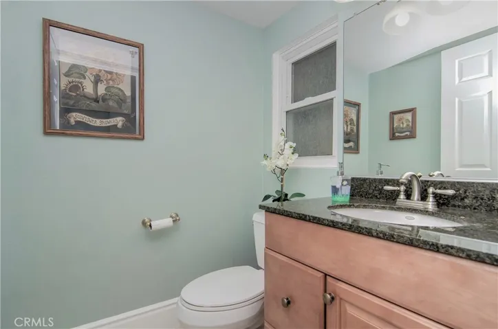 Main level guest bath with soothing paint palette. Note the upgraded base moldings.
