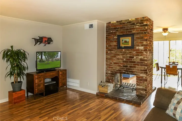 Living room, looking towards kitchen/eating area and back yard