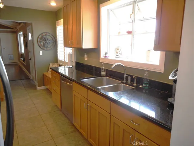 Dark Granite, Shimmering Stainless Appliances, Ceramic Tile Flooring and a Garden Window