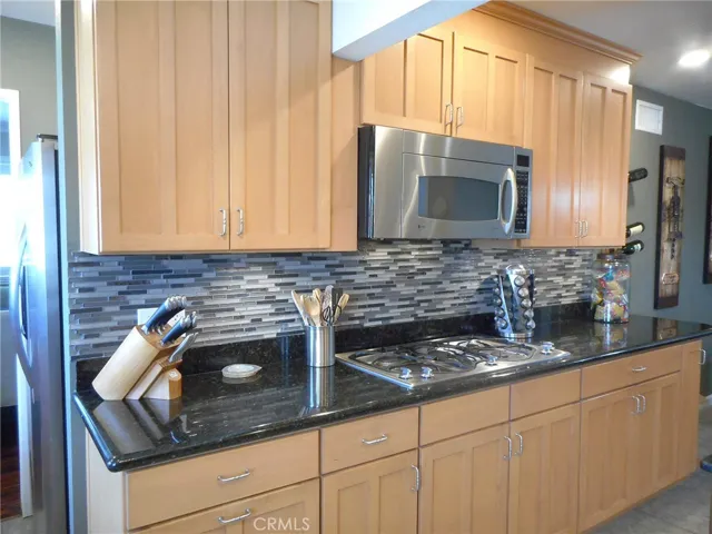 Glass Mosaic Back Splash, Stainless Micro Hood and Beautiful Cabinetry