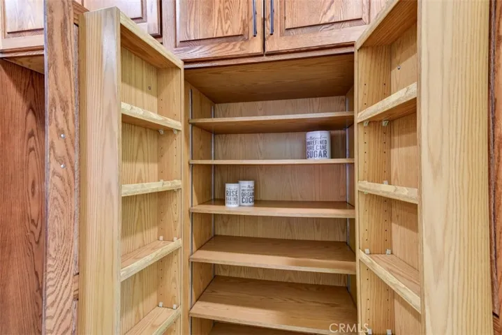 Some very nice convenience features are built into the kitchen cabinets.  Pantry has spice/bottle racks built into the doors.  Most of the lower cabinets have pull-out shelves.  See the other photo showing many of the cabinets open for display.