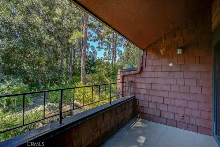 Looking out main floor balcony to babbling brook streams and water falls and path from fron guest parking to your building.