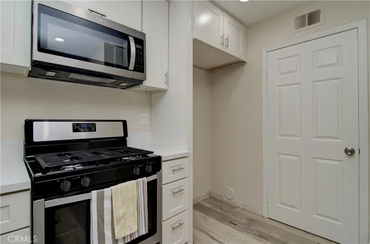 You'll have plenty of room for a large refrigerator in this space. Also, the door seen here opens to the inside laundry room!