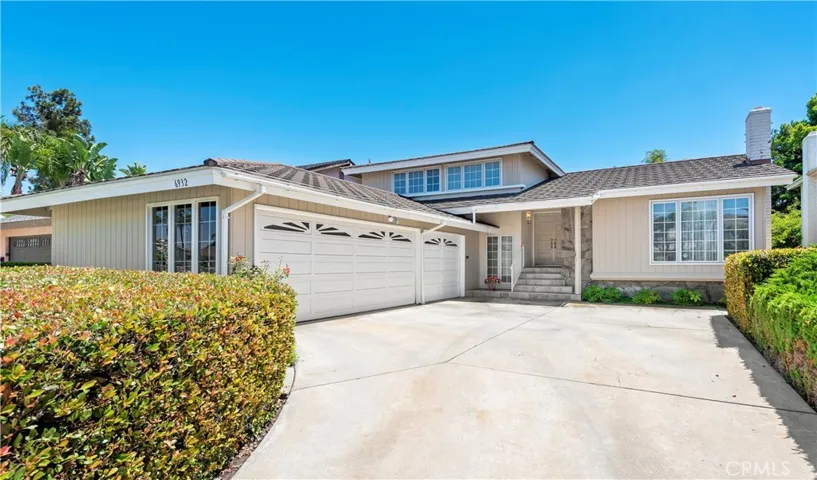 Front of house with 3 car garage.