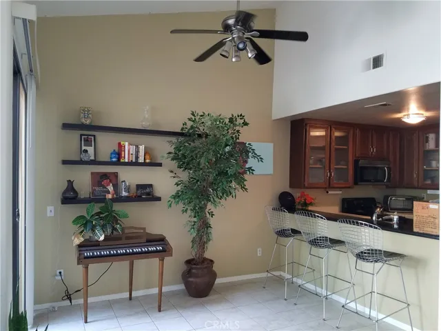 Large Dining area, used as Music space now. Check out the volume ceiling and fan too!