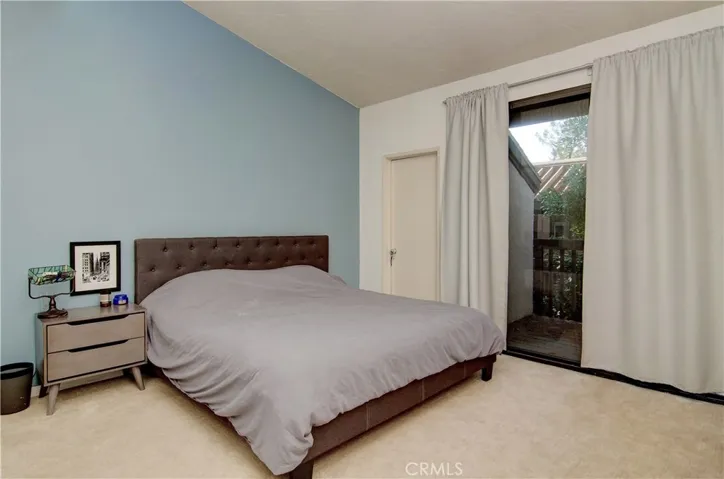 Vaulted ceilings add to the feeling of space in the bedroom. (Yes that's patio no. 2 you see and an extra closet!)