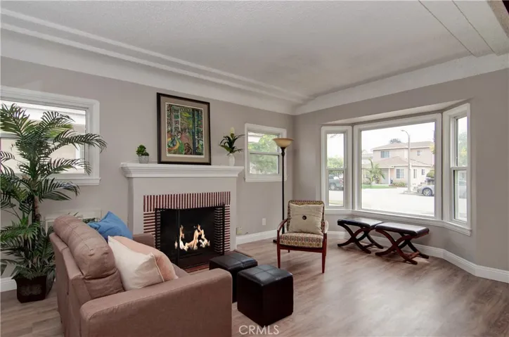 So much architectural style here...tray ceilings, bay window and inviting fireplace.