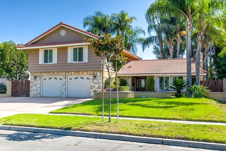 Gorgeous home with large front yard, mature landscaping, 2 car garage and RV parking