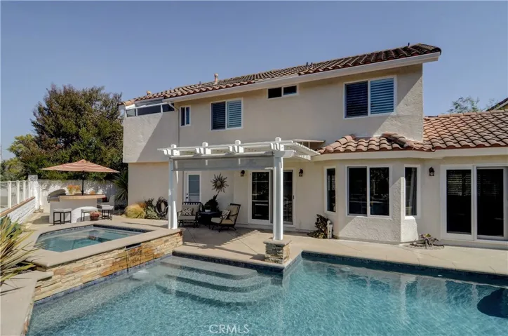 WOW is right...this rear yard paradise has it all...pebbletec pool, spa, BBQ island and fire pit...plus nature views all around...