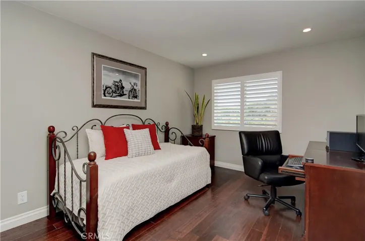 Additional kids/guest room has large wardrobe closet and beautiful hardwood floors.