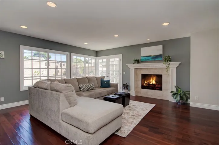 Family room has cozy fireplace and French doors to back yard.