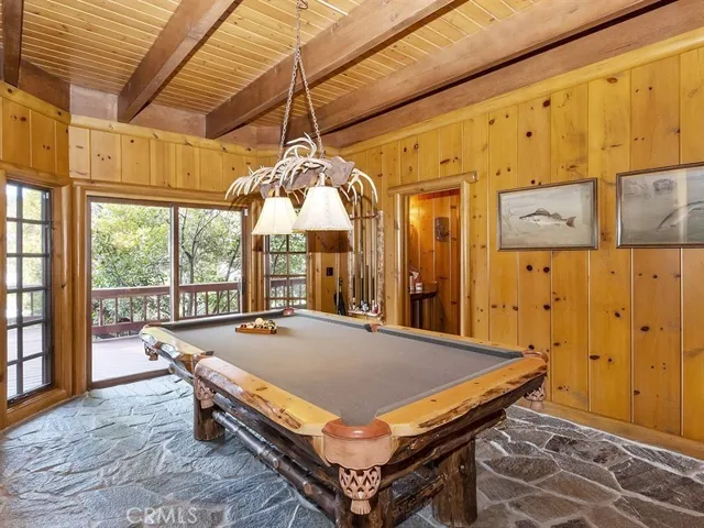 Downstairs game room is adjacent to bar and family room and opens out to spacious deck on the golf course.