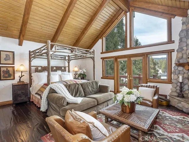 Master suite with stone fireplace and expansive golf course views