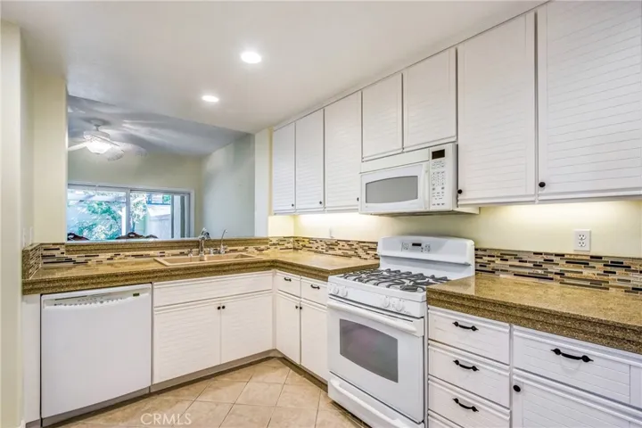 Beautiful Counter Tops and back splash. Kitchen opens to Dining Room