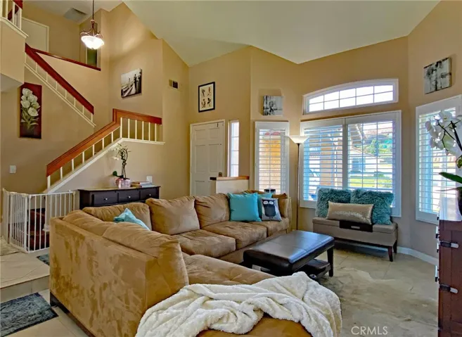 Entry with Open Staircase to Upstairs Loft, Master and 2 additional bedrooms.  Tile thru-out the lower level with laminate wood on stairs and carpet in bedrooms.  Shutters thru-out and windows have been replaced.