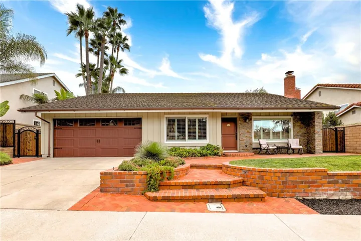 Beautiful curb appeal with new carriage style garage door, Damner shutters and brick detail.