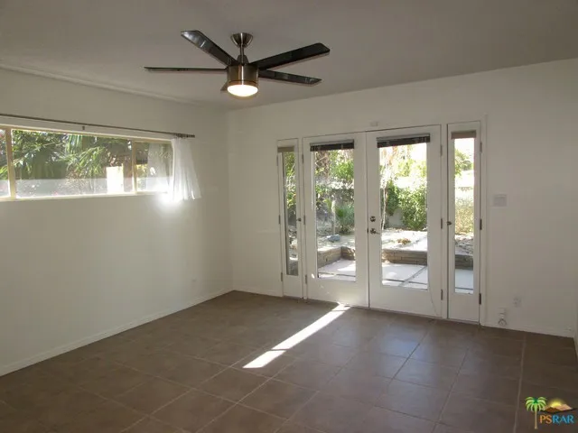 Guest bedroom with french doors leading
