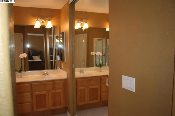 Has large walk-in closet, mirrored doors, stall shower and oval tub