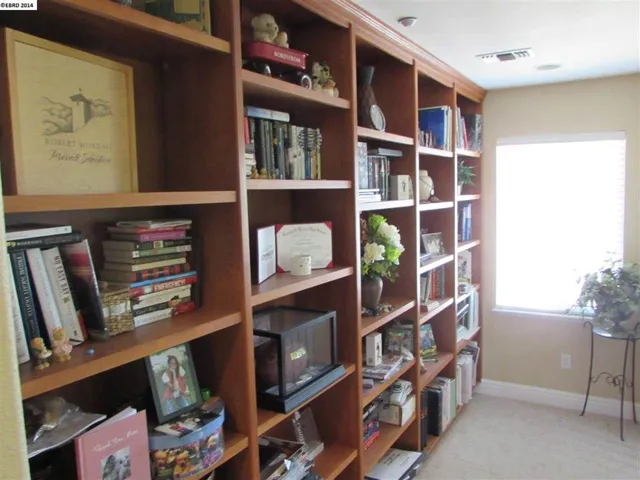 Enjoy a huge wall of custom shelving in this open sitting area