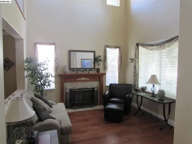 Shows gas fireplace, hardwood floor