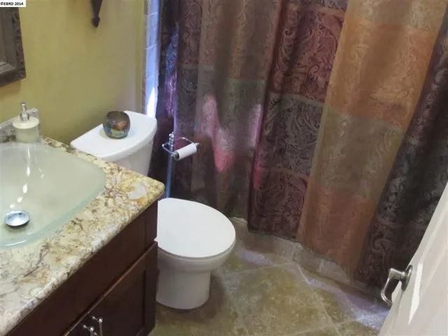 Fully upgraded with granite, vessel sink, waterfall fixture, stone floor and shower, seamless glass