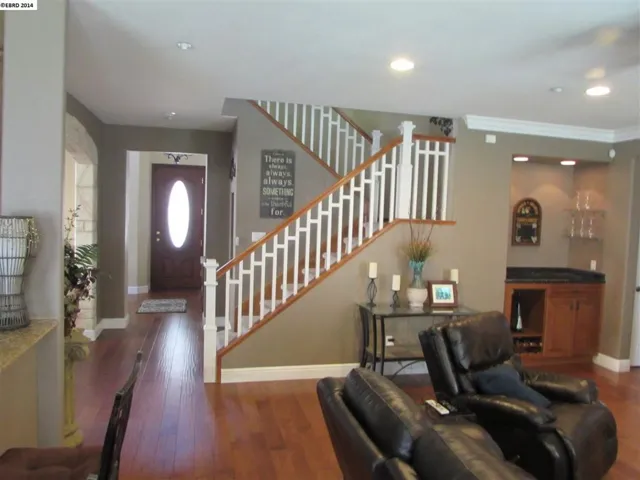 Beautiful front door and hard wood flooring. Built-in cabinet has wine rack, room for wine fridge.