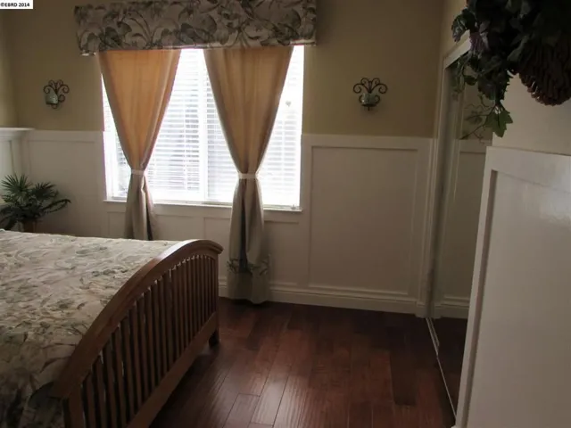 Shows hardwood flooring and wainscoting