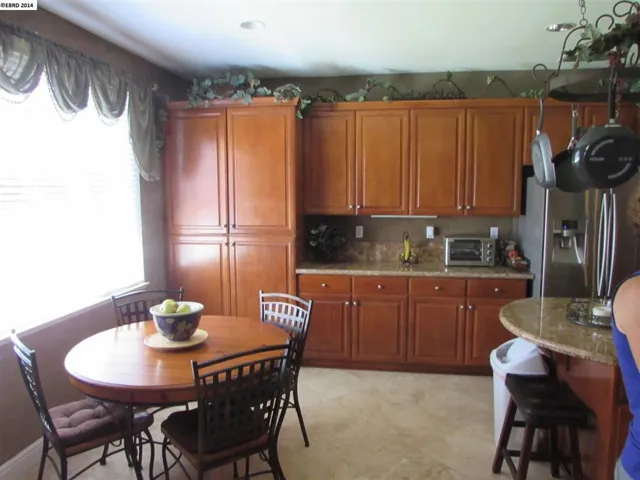 Shows tile flooring and extra cabinetry