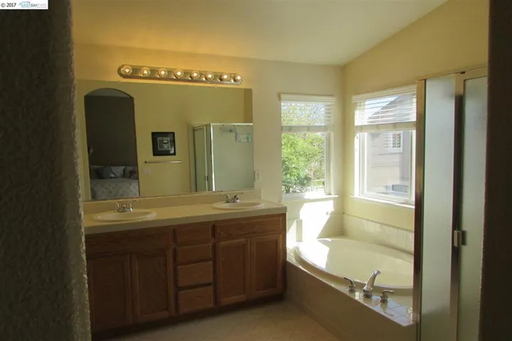 Master bath has a stall shower and separate soaking tub. The walk-in closet is roomy with new carpet